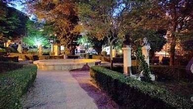 Memshiyeh Park at night in Zahlé, tree-lined walkway with statues