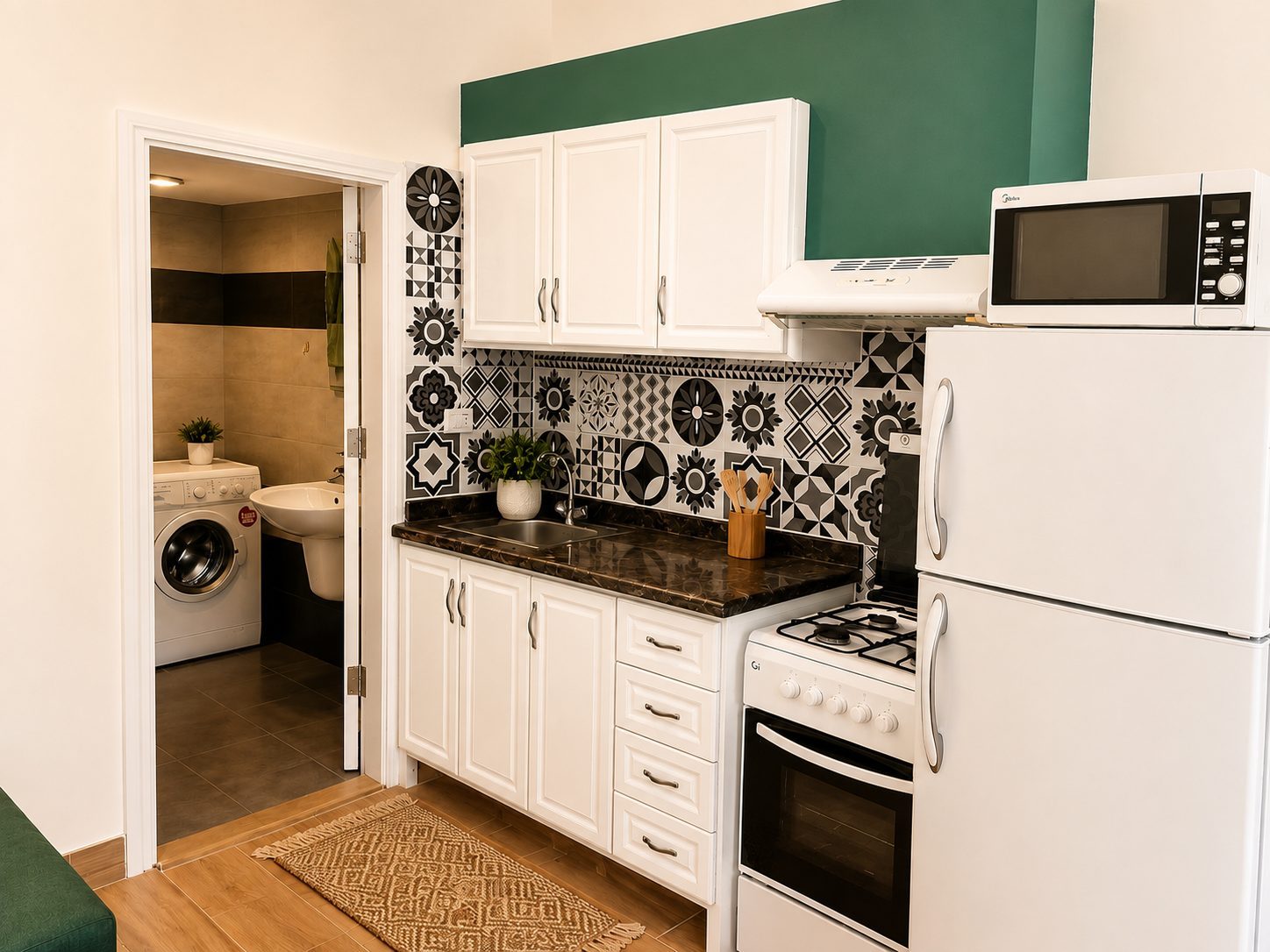 Berdawny Apartments studio full kitchen with fridge, stove, and washer visible through doorway